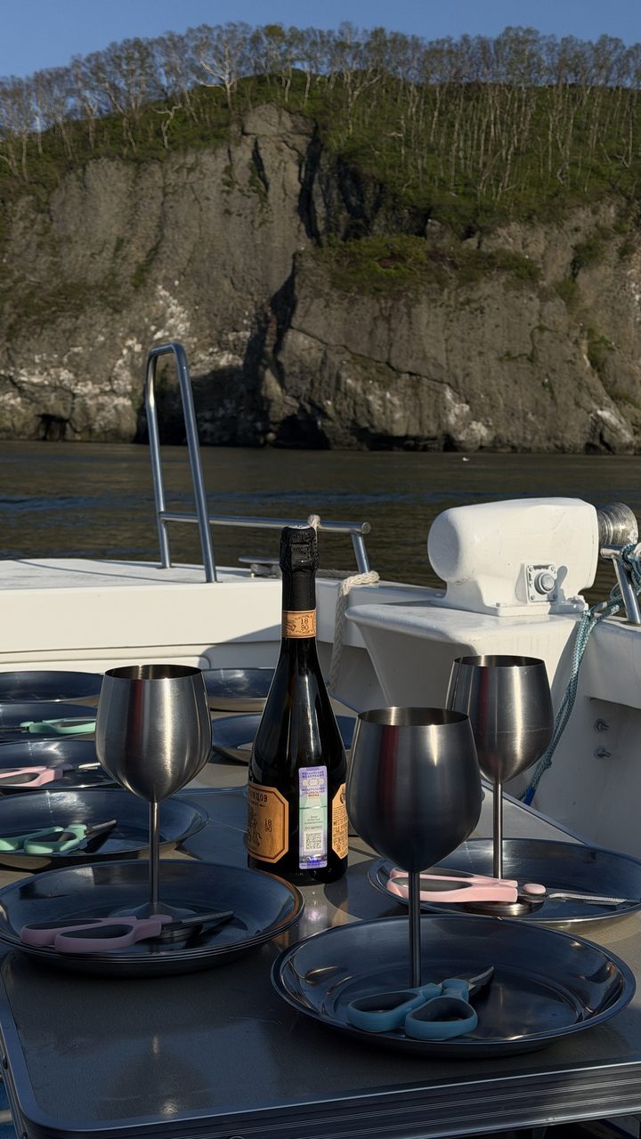 Set table on deck against the green Kamchatka cliffs