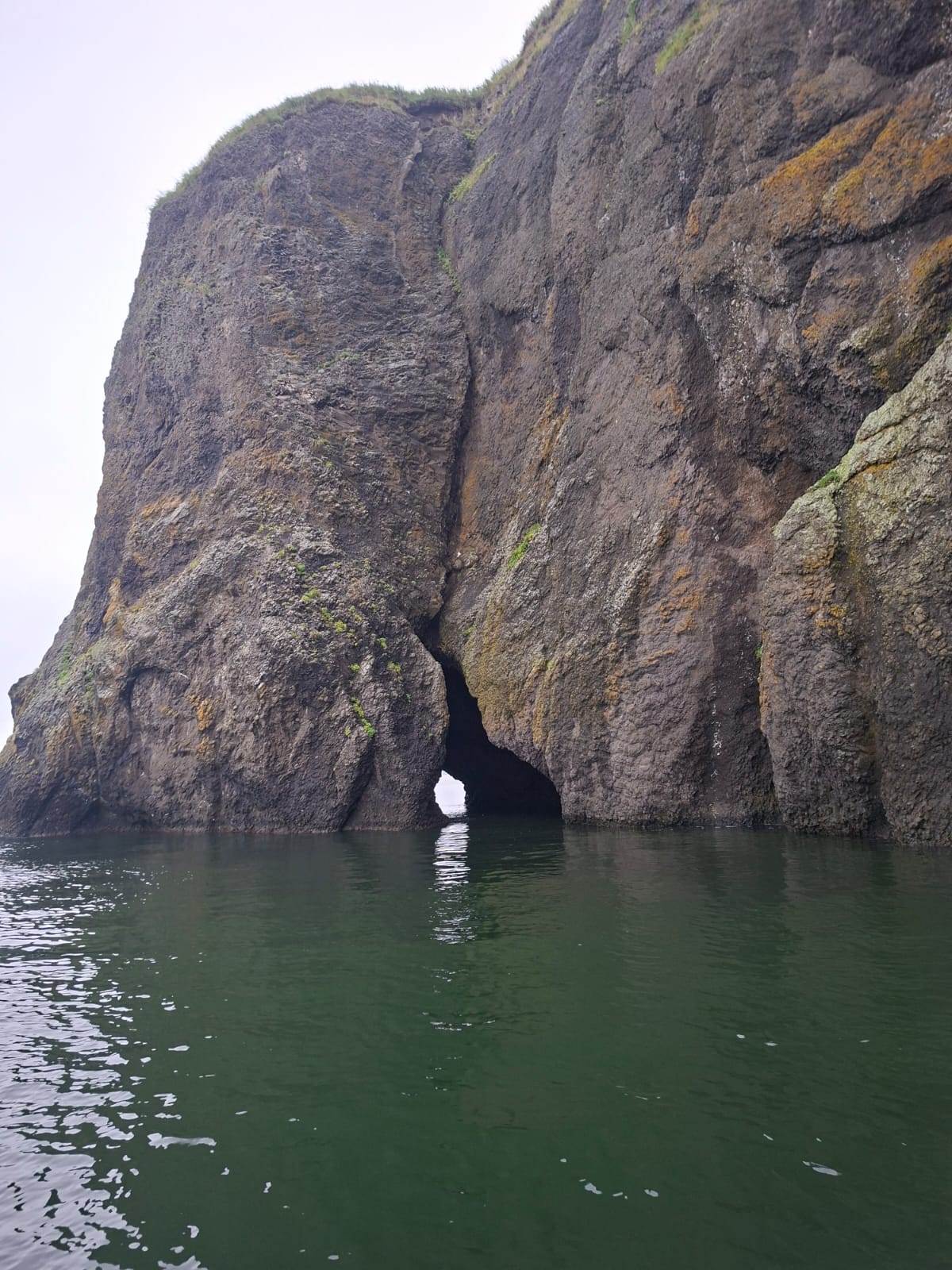 Sea arch in the cliffs near the Kamchatka coast
